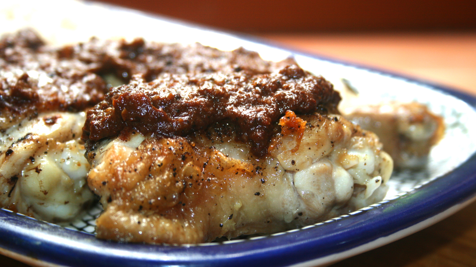 Chicken tenders in mole sauce on a bed of rice