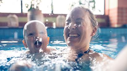 Mom and baby swimming in pool