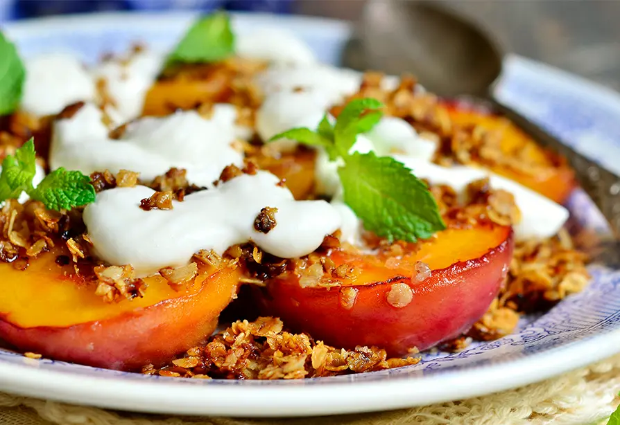 Pêches grillées arrosées de vinaigrette au yogourt, dans une assiette