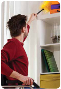 Young man dusting some furniture. 