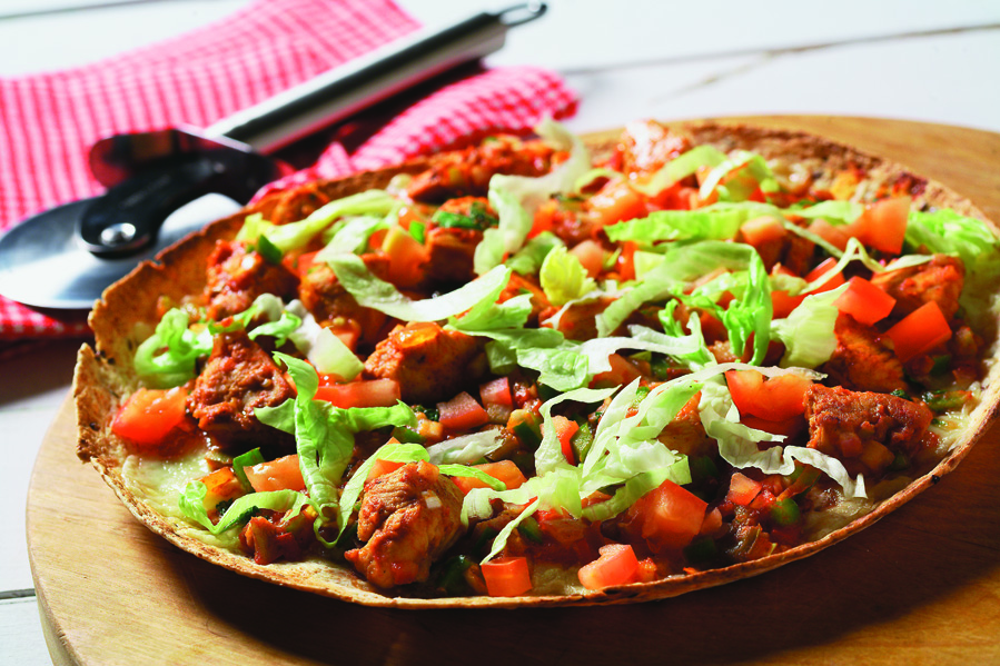 Pizza on a plate with pizza cutter