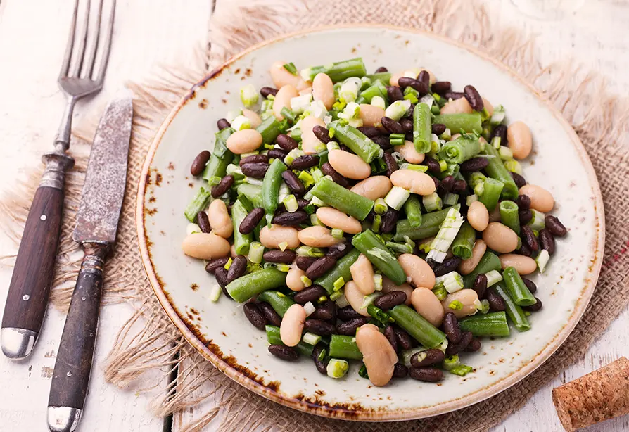 Une assiette de salade de haricots mélangés.