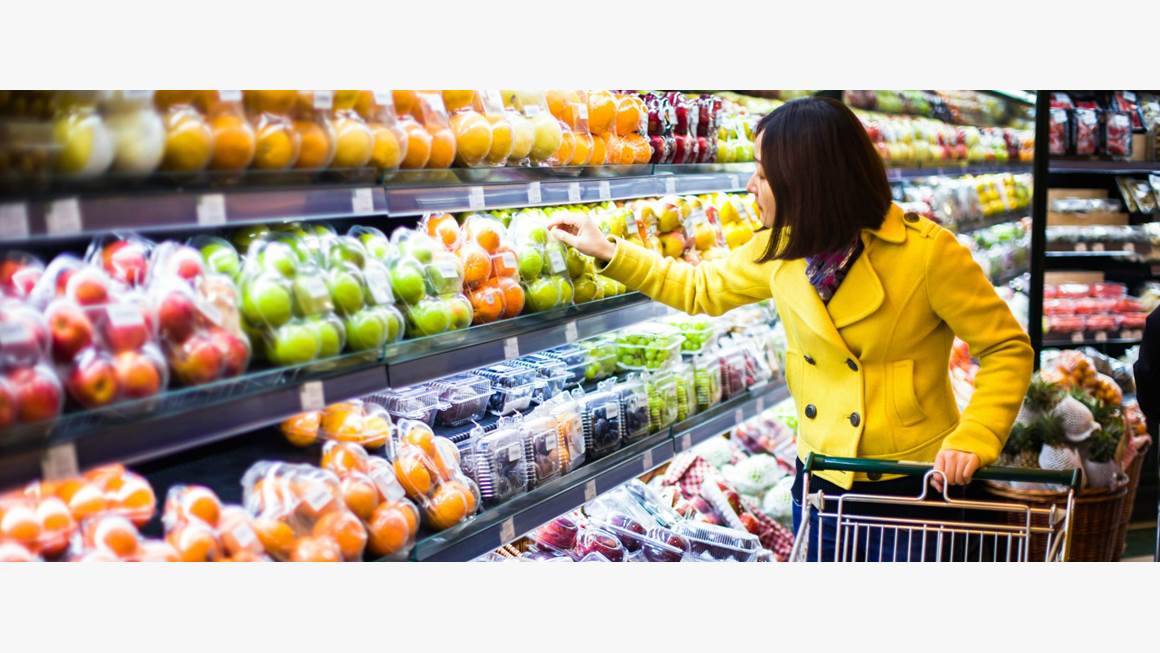 Woman shopping for fruit in grocery store